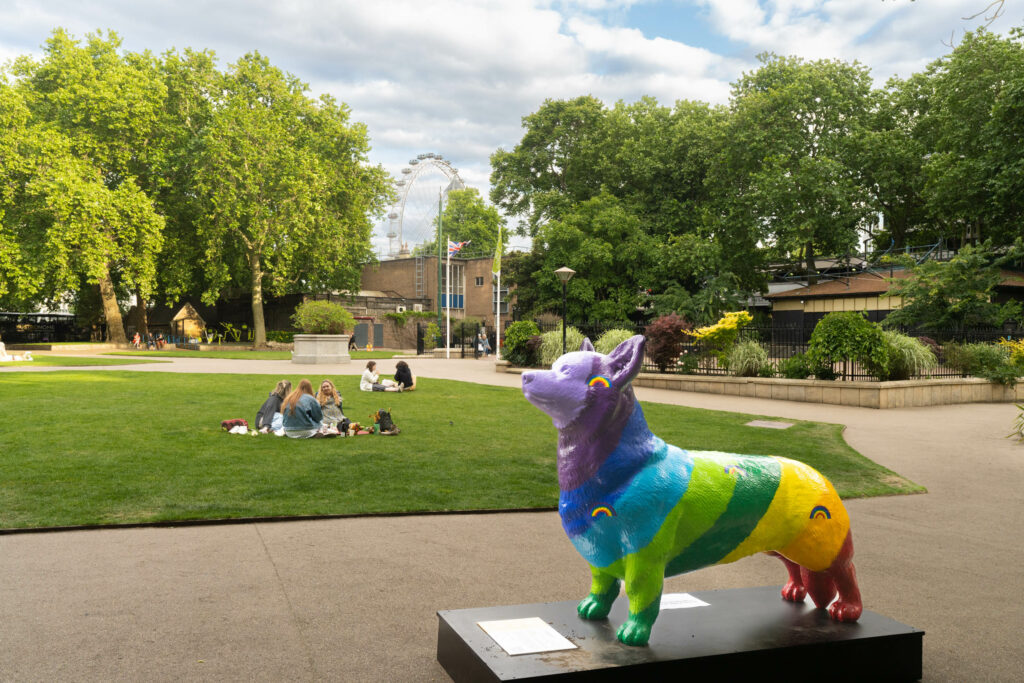 A multicoloured corgi installation stands in a park overlooking the London Eye, as part of We Are Placemaking's famous Corgi Trail to celebrate the Queen's Platinum Jubilee across London in 2022