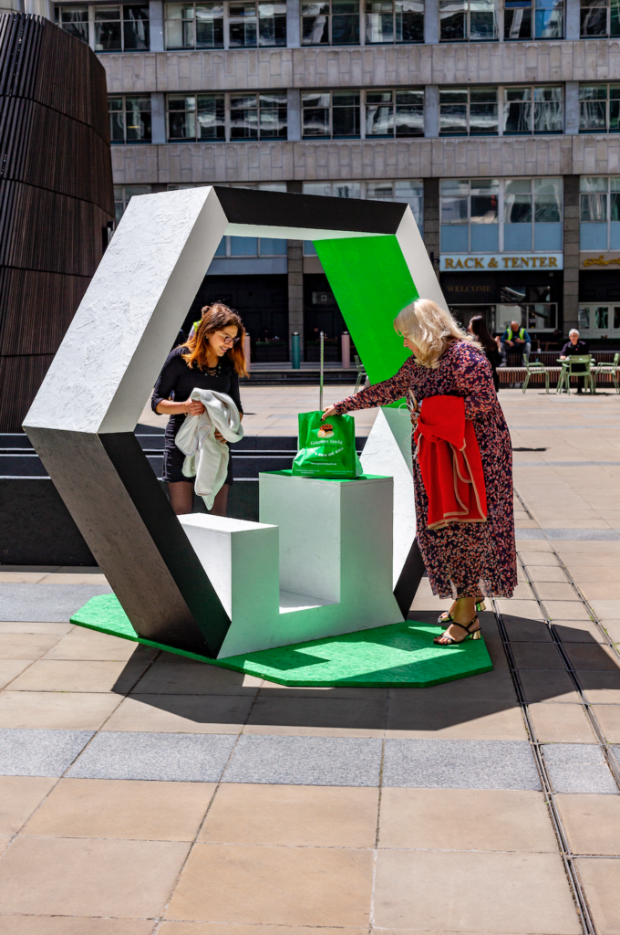 Two women enjoy interacting with unique black, white and green seating at We Are Placemaking's Summer Chess Activation for Brookfield City Point, a landmark tower in the City of London 