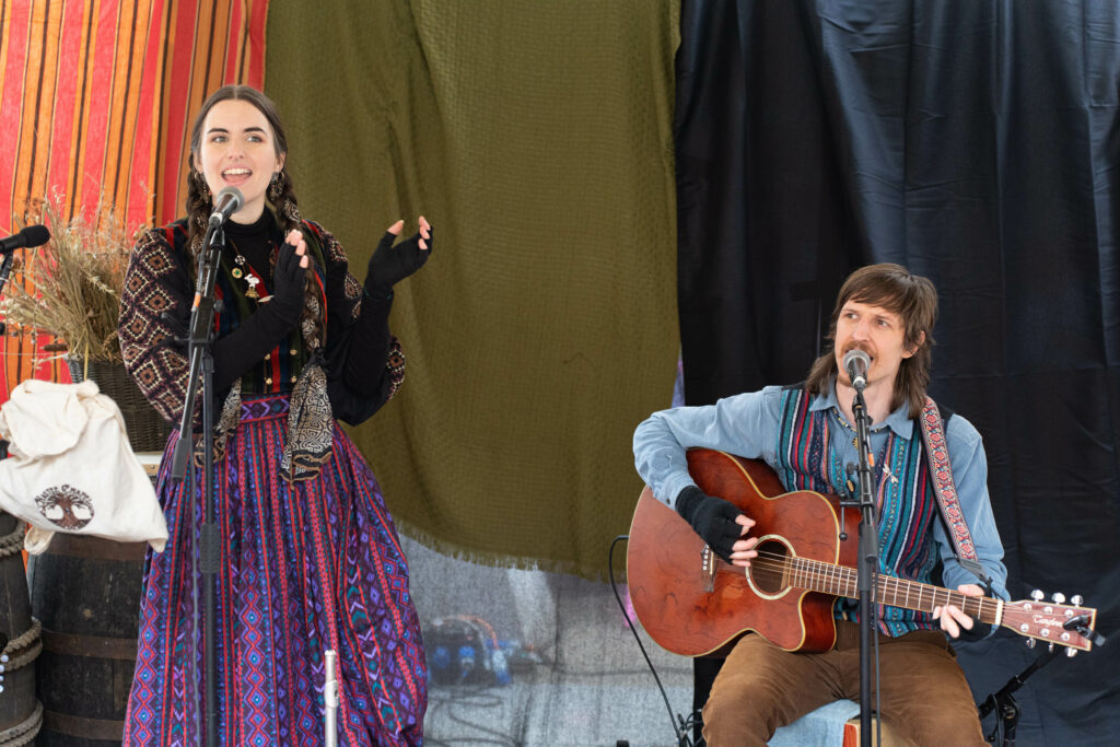 Duo (woman sings while man plays guitar and sings) performing at the Frost Fair