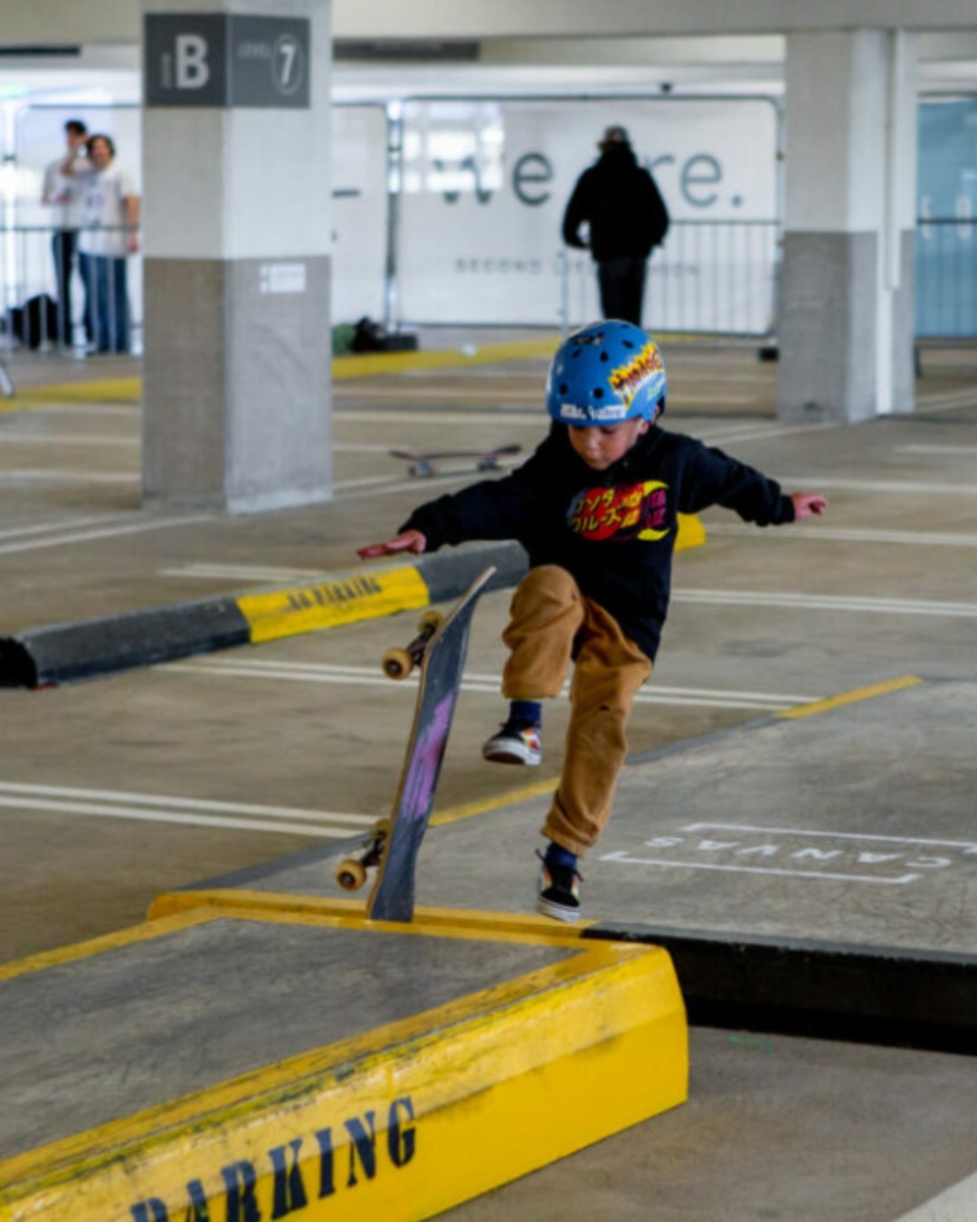 A young boy performing tricks at the Cabot Circus Skate Park in Bristol