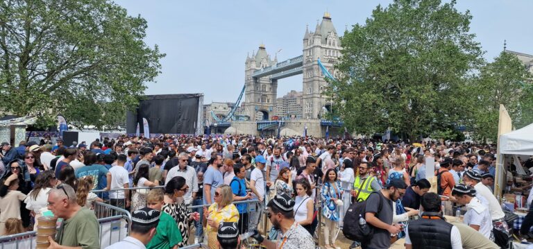 Crowds gather at Uzbek Culture and Food Festival in Potters Field Park, London, June 2023 - with Tower Bridge in the background