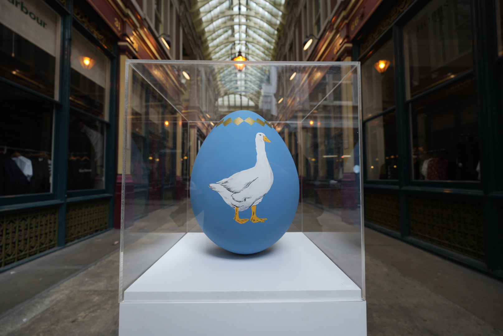 An blue Easter Egg with a duck painted on it is on display in a box at Leadenhall Market, as part of the Easter trail for EC BID