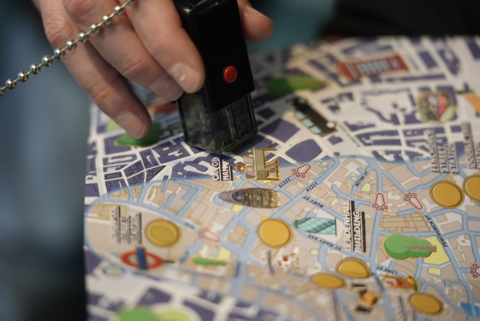 A zoomed in image of people stamping their map at one of nine Easter egg stops, as part of the Easter trail for EC BID.