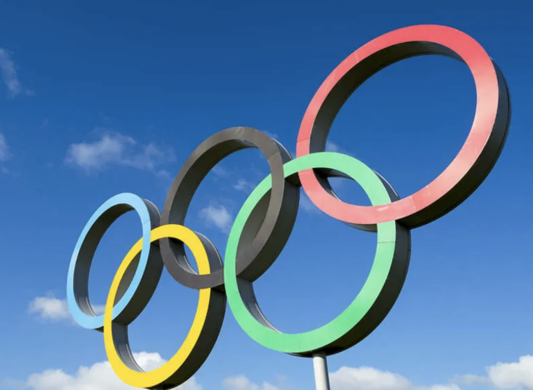 Olympic ring structure against a backdrop of blue sky