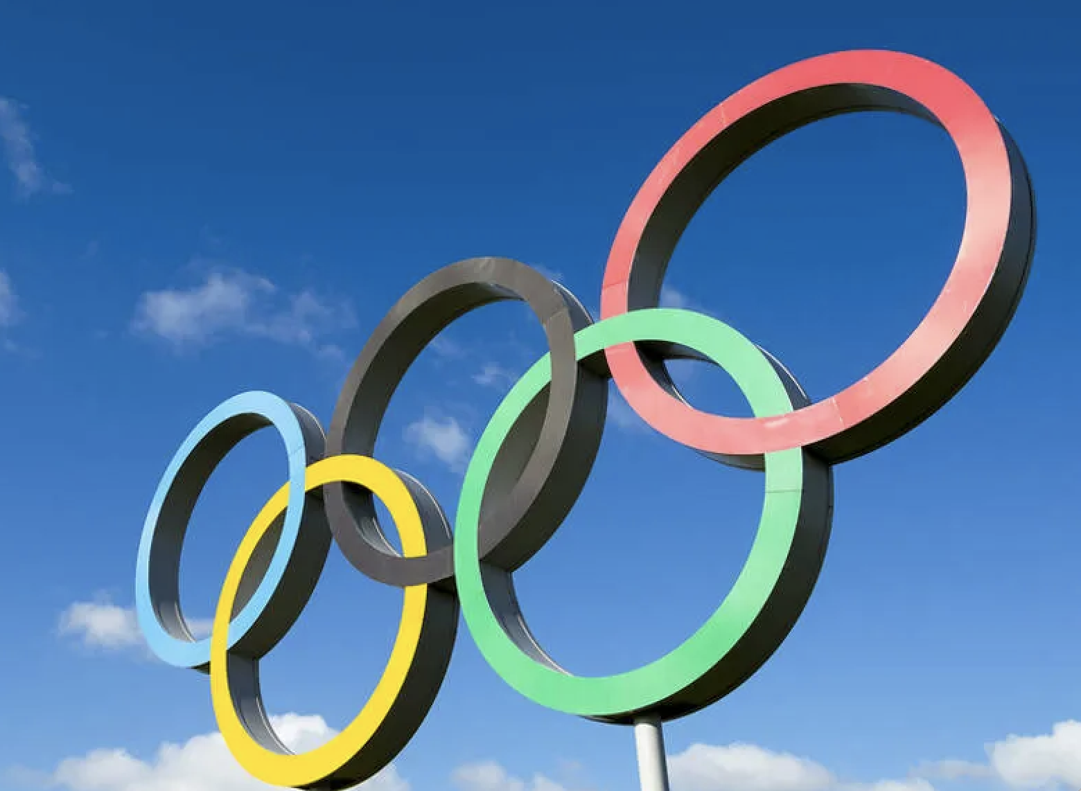 Olympic ring structure against a backdrop of blue sky